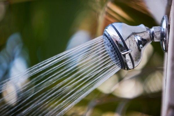 Close-up of a showerhead with water flow.