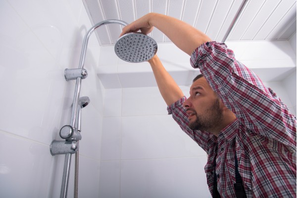 a person inspecting a shower head